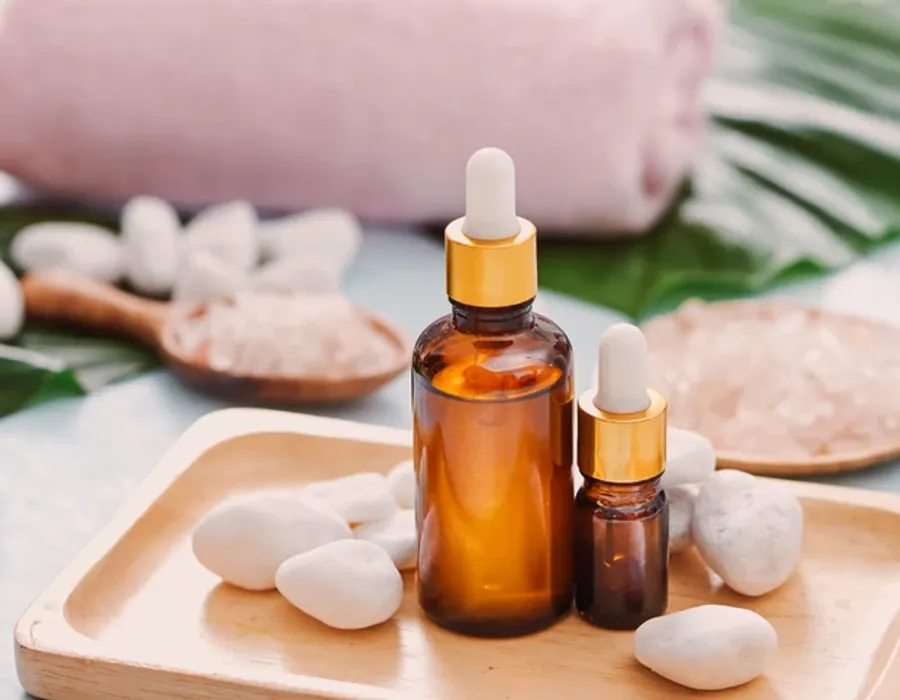 Amber essential oil dropper bottle and white diffuser stone on a wooden tray | Made Studio Taipei perfume blending experience